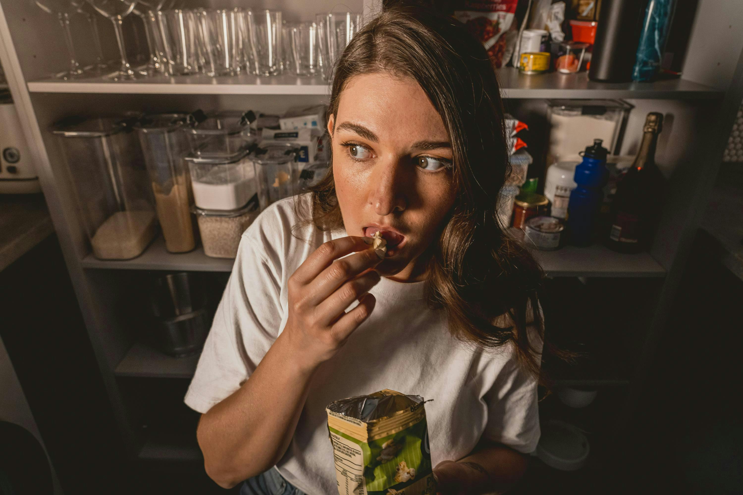 woman snacking in the pantry